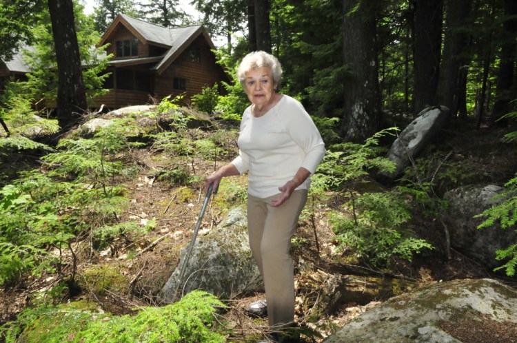 Staff photo by David Leaming
Doris Jorgensen speaks on Tuesday at the boundary line near her home on Long Pond in Rome, where a proposed boys summer camp might be built.