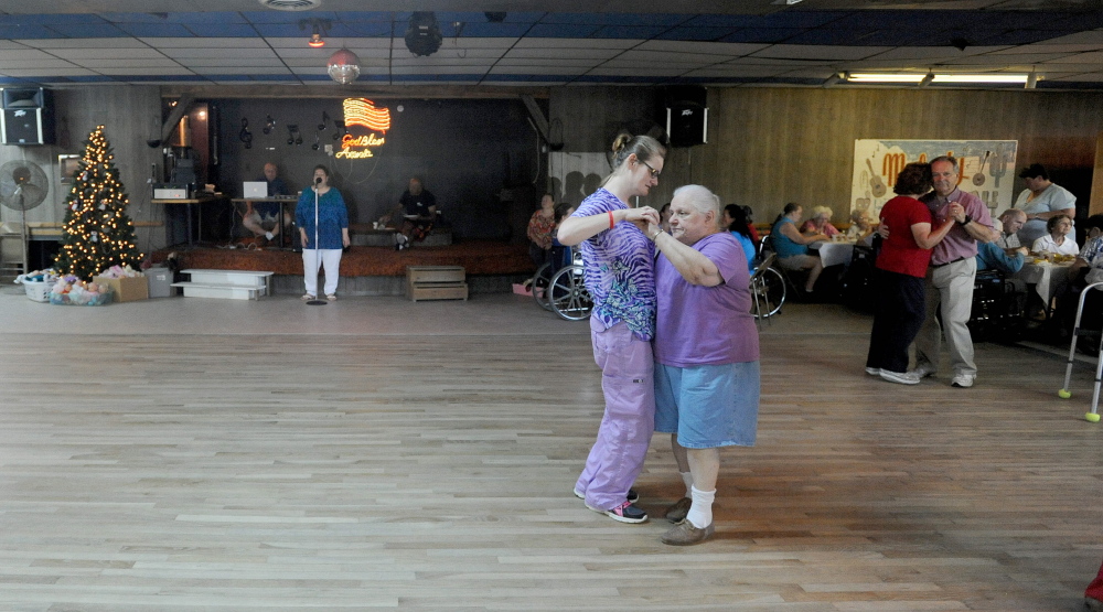 Lucille Chartrand, right, dances with Kim McGruder on Thursday during the Christmas in July celebration at Melody Ranch in Fairfield.