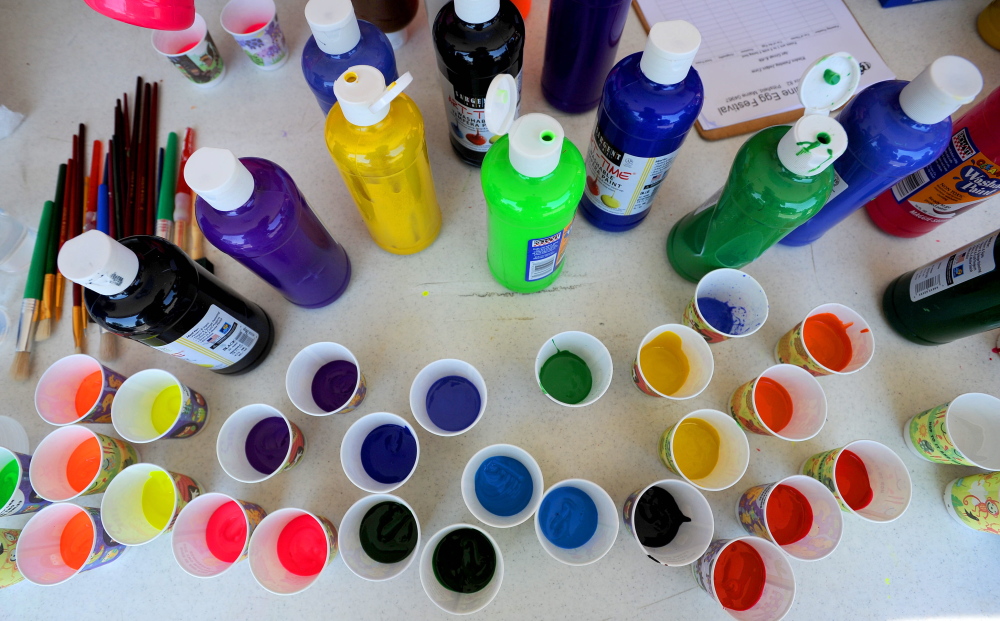 Local children gather on Main Street in Pittsfield to paint storefront windows with egg-inspired art on Thursday, day four of the 43rd annual Central Maine Egg Festival.