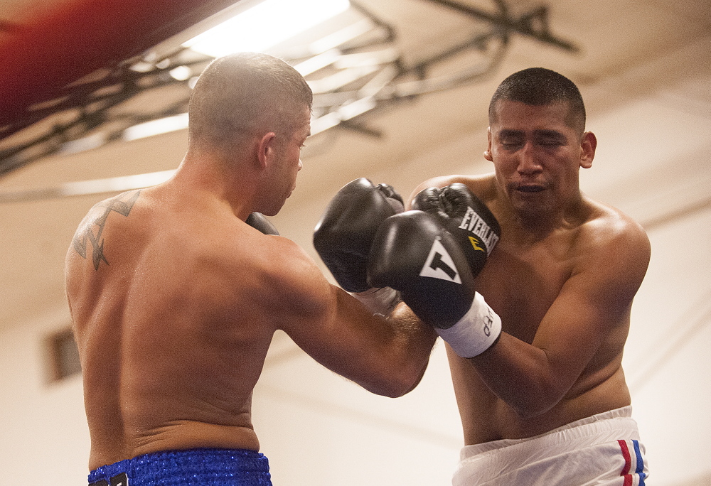 West Forks native Brandon Berry, left, fights Mexican professional boxer Engelberto Valenzuela on Saturday night at the Skowhegan Rec Center.