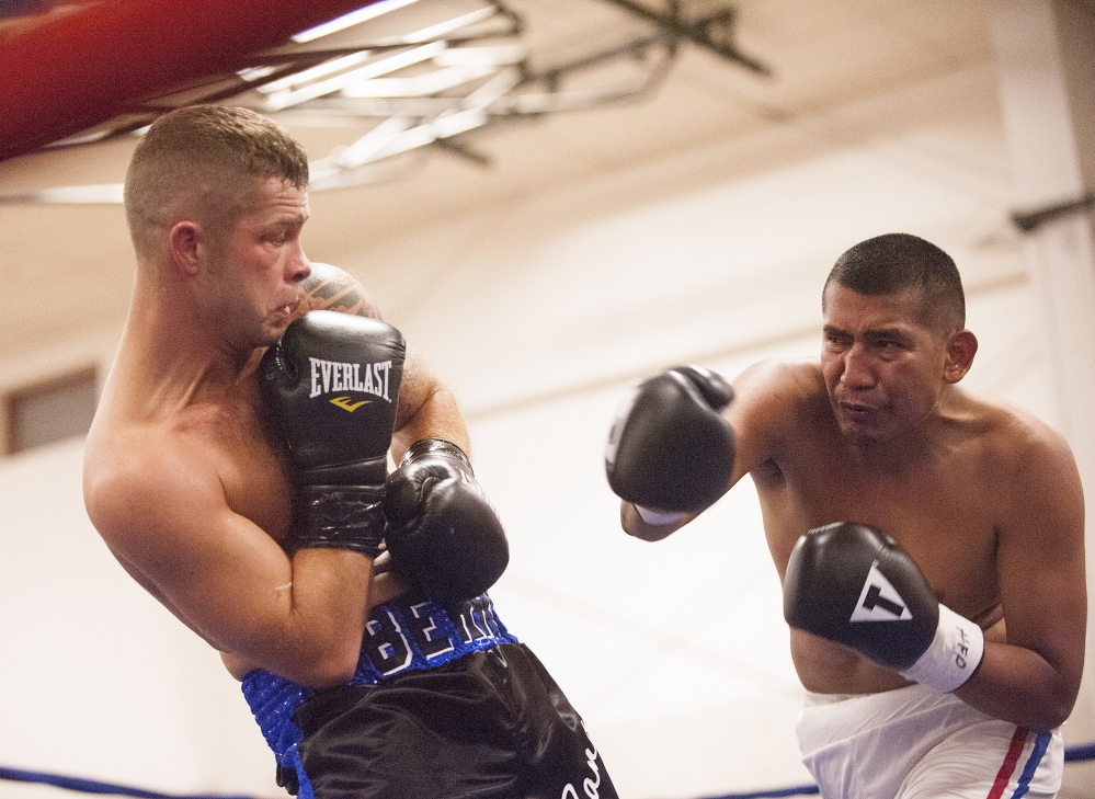West Forks native Brandon Berry, left, fights Mexican professional boxer Engelberto Valenzuela on Saturday night at the Skowhegan Rec Center.