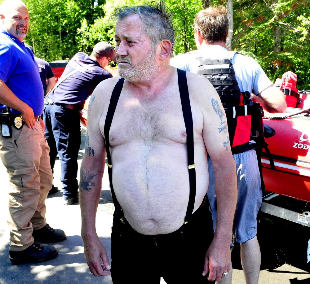 Boater Llewellyn Ryder, 66, of Clinton, speaks with investigators after he and his small boat overturned in the choppy water of Lake George in Canaan on Wednesday.