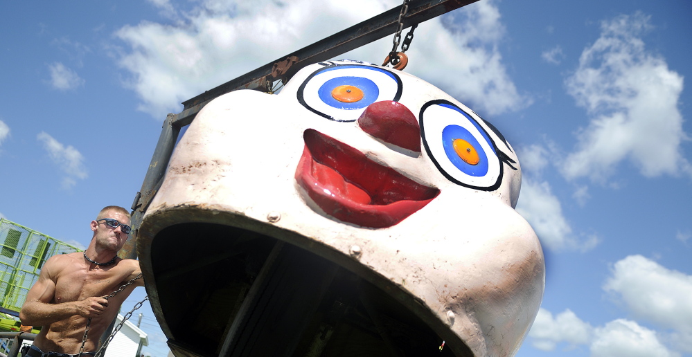 Bob Donovan hoists a ride onto a track at the Pittston Fair on Wednesday. Kavanaugh Amusements is offering 11 rides to visitors at the agricultural exhibition.