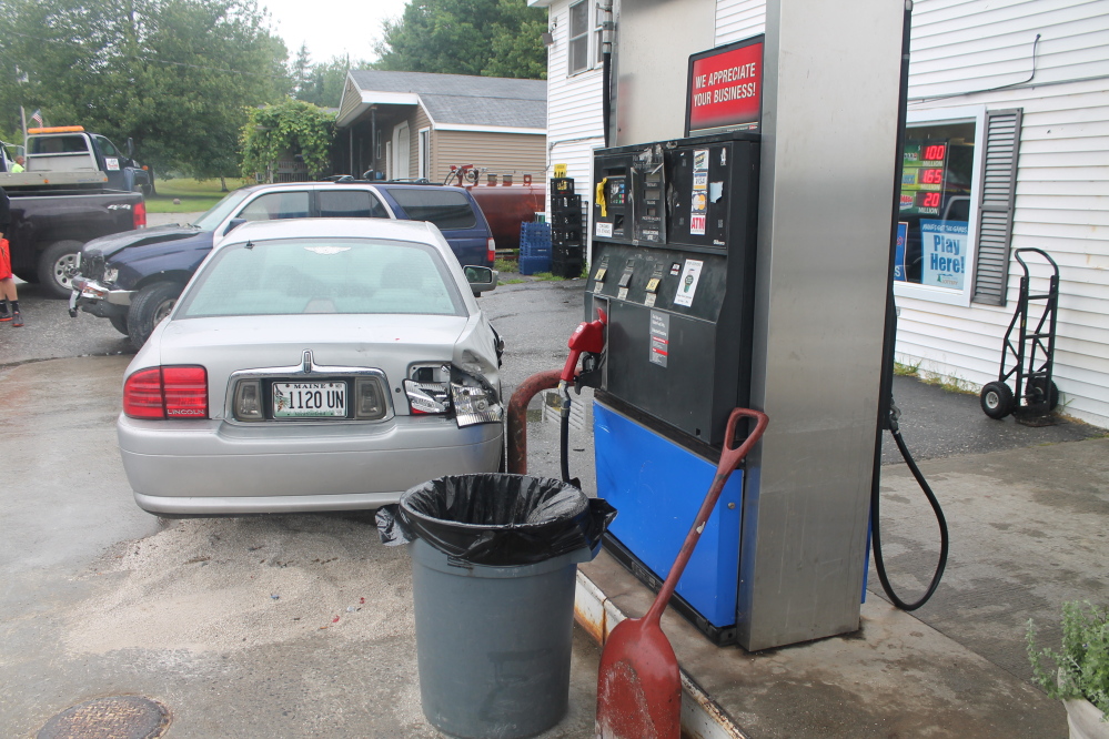 A driver running a stop sign at Four Corners General Store in West Gardiner caused an accident involving three vehicles, including the silver Lincoln sedan in the foreground and the blue Toyota SUV behind it.
