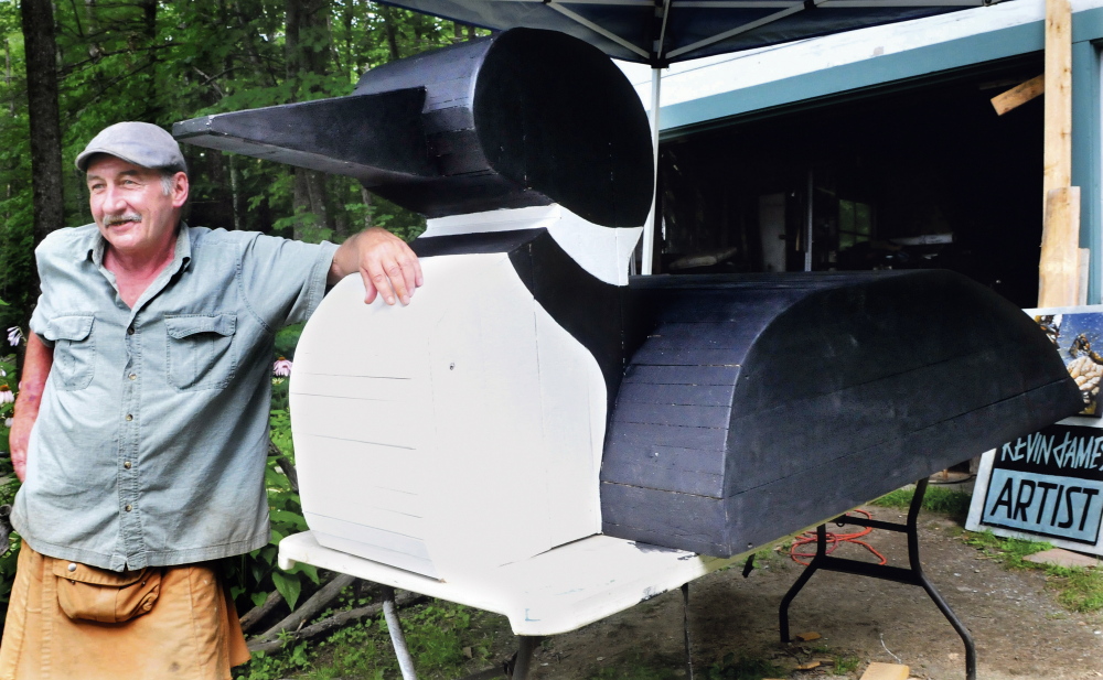 Artist Kevin James on Wednesday stands beside part of his loon float, which will be part of the Smithfield 175th Anniversary Celebration this weekend.