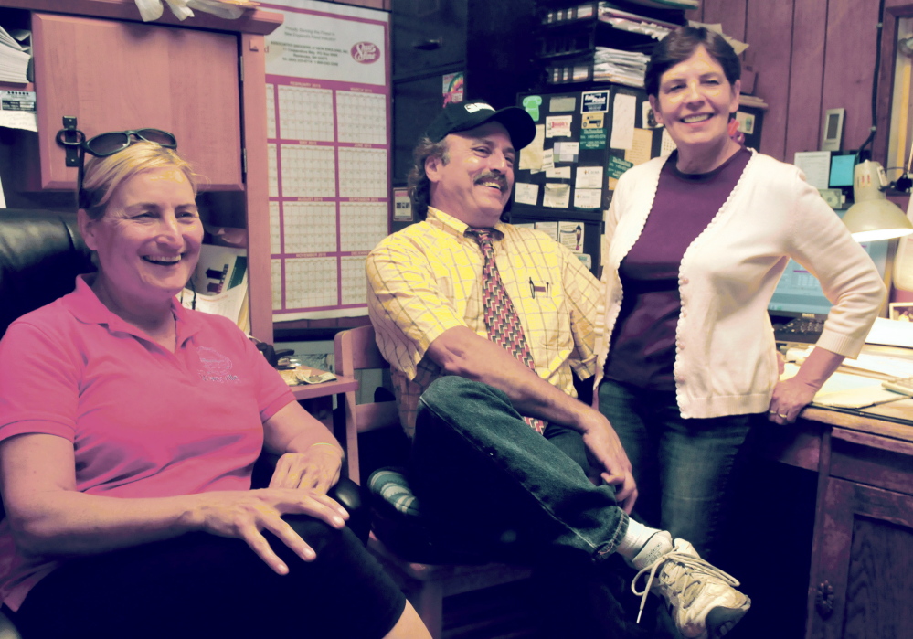 Sitting in a back room at Joseph’s Market in Waterville on Thursday, business owner Kevin Joseph and his wife Diane, right, discuss funding the Festival of Falls along with coordinator Karen Rancourt-Thomas. The city cut funding for the September multi-cultural festival from the city budget, but the Josephs have made a contribution toward keeing the event alive and hopes over local businesses will too.