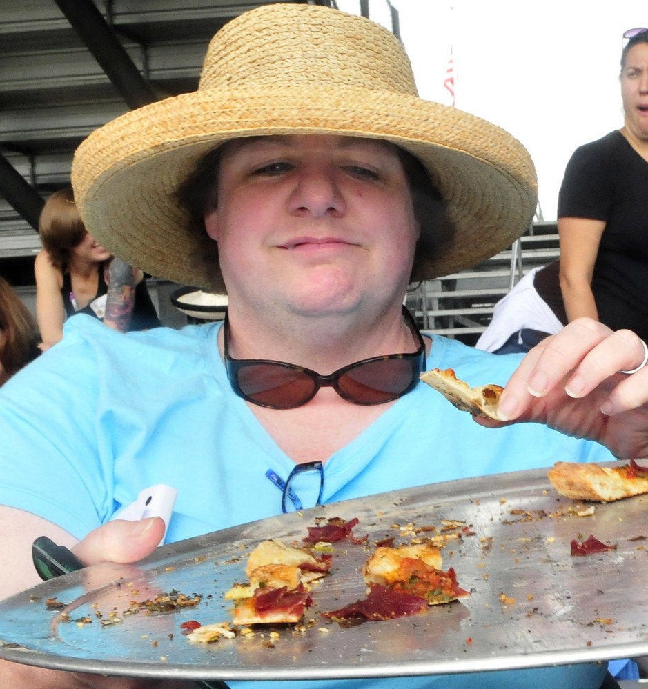 Kelly Clark samples pizza cooked in a wood-fired oven during the ninth annual Kneading Conference in Skowhegan on Thursday.