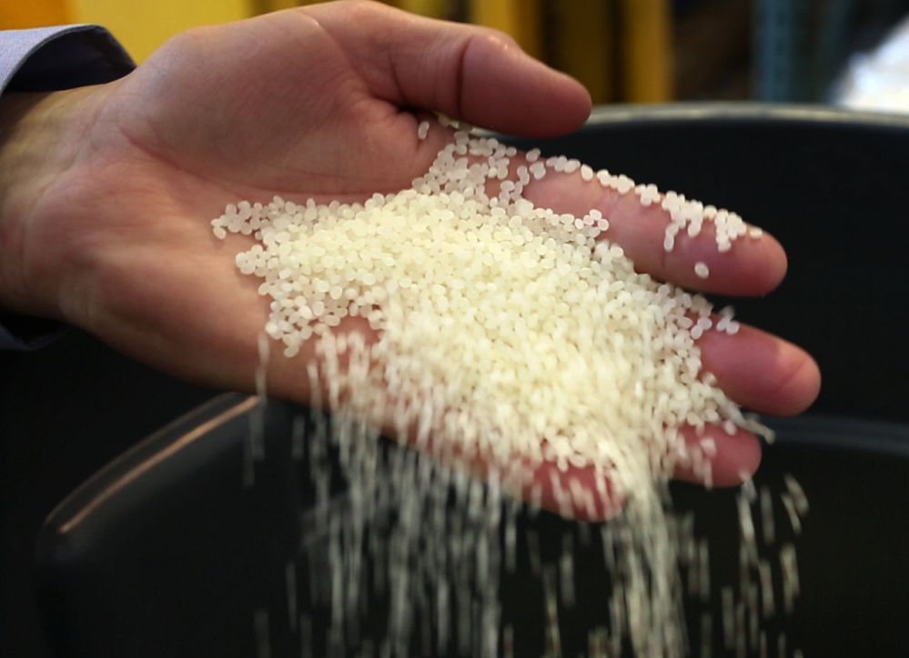 In this photo taken, Friday, June 12, 2015, a batch of milled rice is inspected at the Blue Current Brewery in Kittery.