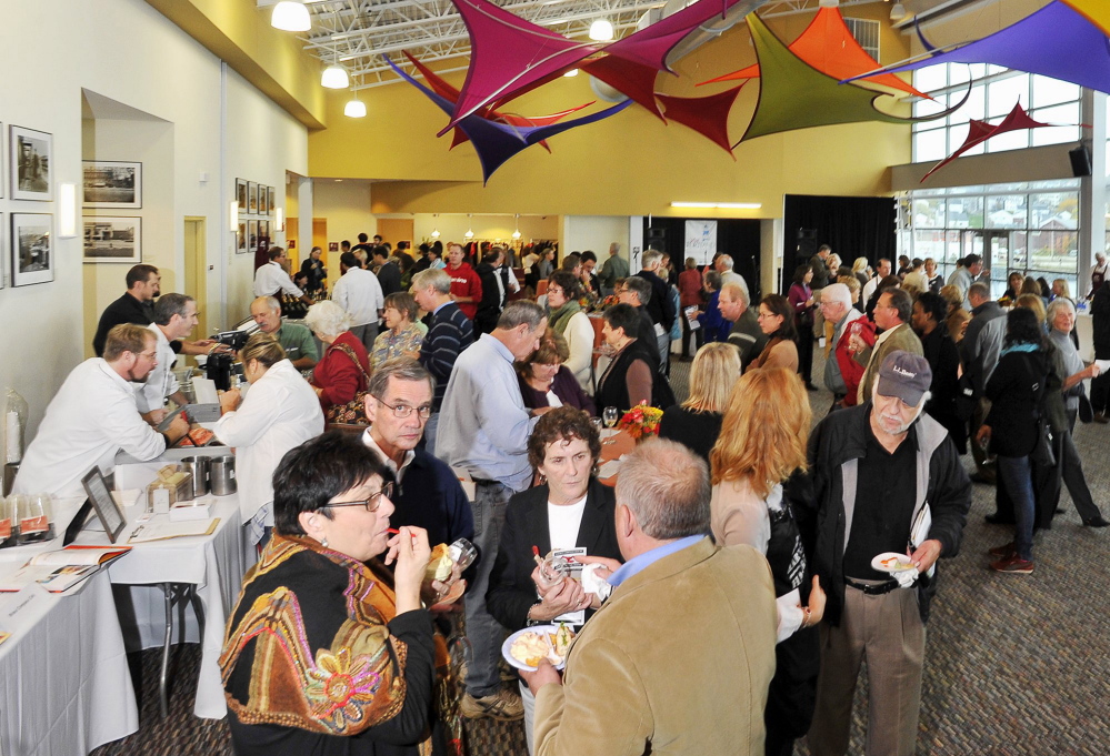 Patrons enjoy the food at the annual Harvest on the Harbor at Ocean Gateway in Portland. Of the culinary tourists to Maine last year, more than 60 percent said they ate lobster or other seafood, while 36 percent consumed Maine specialties such as whoopie pies and Moxie.