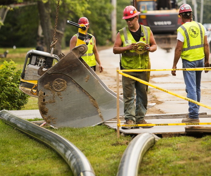 Workers for Summit Natural Gas of Maine install pipeline on Portland Street in Yarmouth. Oil and propane dealers are battling the new competition from gas in Falmouth, Cumberland and Yarmouth with an ad campaign.