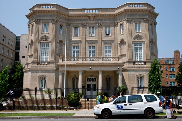 A U.S. Postal Service worker on Wednesday unloads packages in front of the Cuban Interests Section in Washington, which serves as the de facto diplomatic mission of Cuba to the United States. The Associated Press