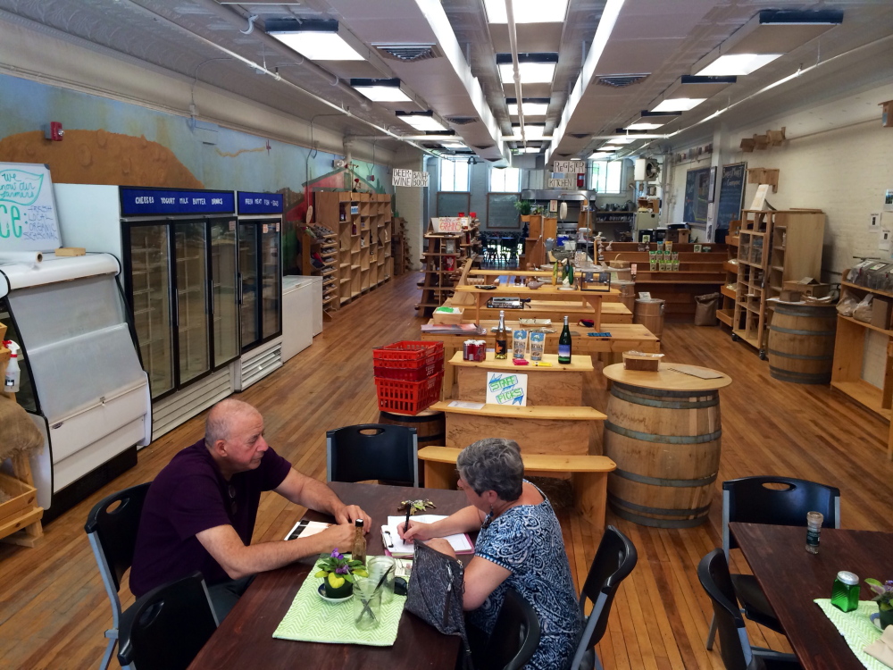 David Shipman, left, and Jennifer Strode, board members of Waterville Food Cooperative, discuss plans for the reopening of Barrels Community Market on Monday. The market plans to relaunch in September with more prepared food offerings.