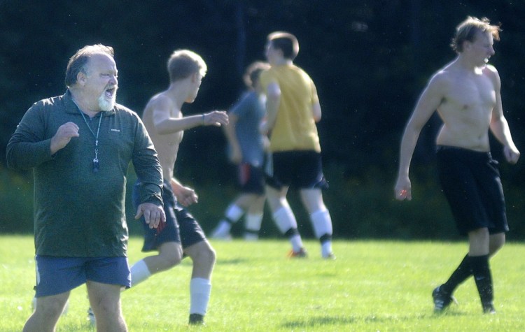 Staff file photo by Andy Molloy 
 Maranacook Community High School soccer coach Don Beckwith instructs his players during the first practice of the 2014 season. Beckwith says the mandatory hands-off period is good for players and coaches.