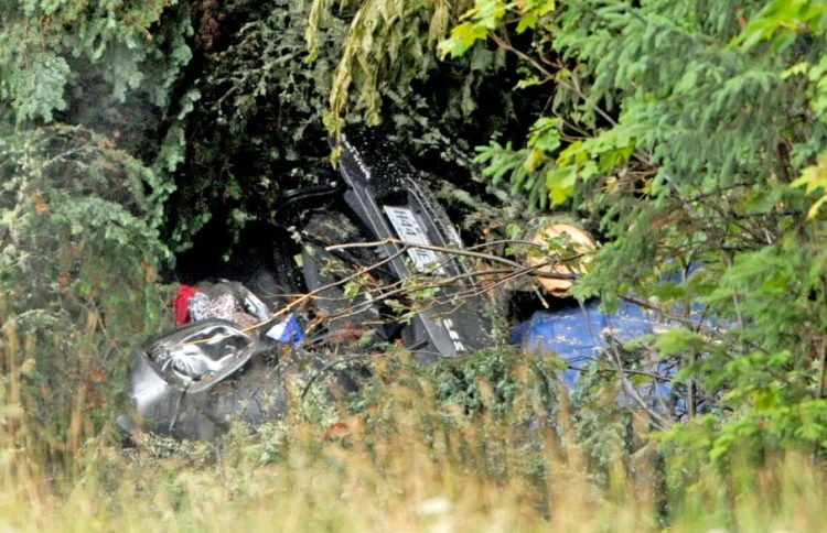 The scene on U.S. Route 201 Tuesday, where Martin Poulin and Francine Dumas, both of Quebec, were found dead in their car in West Forks Planttion. The couple had been missing since they left Quebec for a wedding a week ago. Police said the car hit a tree and it fell, blocking the accident from sight.