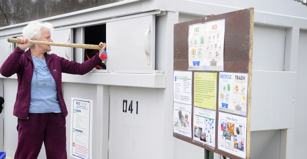 Augusta Public Works director Lesley Jones tamps items inside the recycling station located at Augusta Public Works to make way for other deposits in this April file photo.