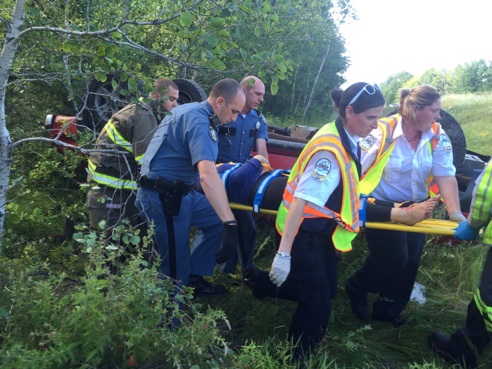 First responders remove Elizabeth Pratt of Hebron from her vehicle following an accident on Interstate 95 in Sidney Thursday morning.