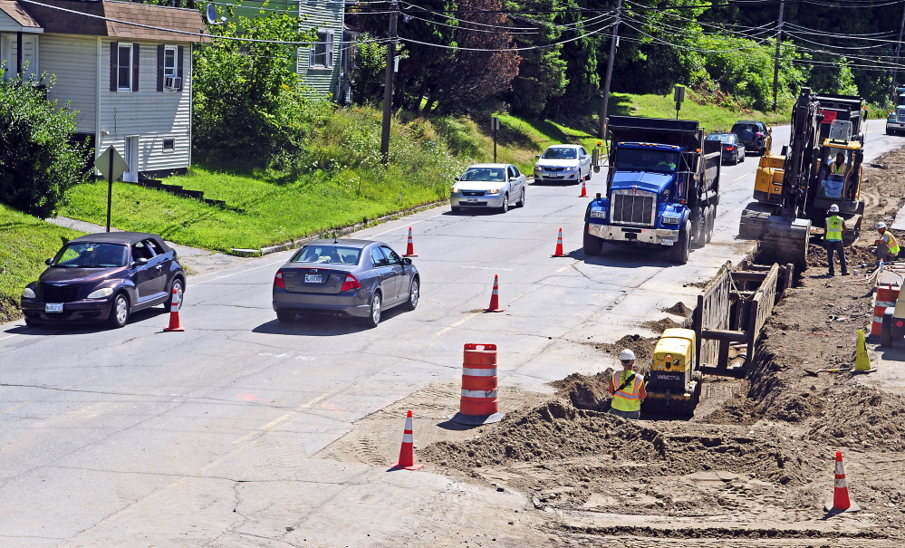 Vehicles drive past College Carryout, which is still open in the construction zone, on Mount Vernon Avenue on Friday in Augusta.