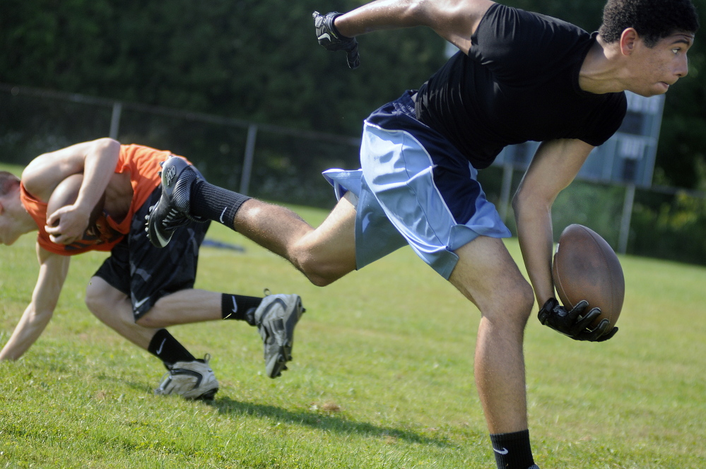Hunter Russell tosses the ball during practice Monday at Gardiner Area High School.