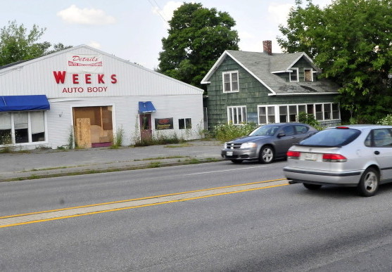 Traffic on Kennedy Memorial Drive passes the site of the former A.L. Weeks & Sons auto body business Tuesday. The property was at the center of a controversial rezoning request taken up Tuesday night by the Waterville City Council. The council voted not to rezone the property to allow a car and dog wash to be established there.