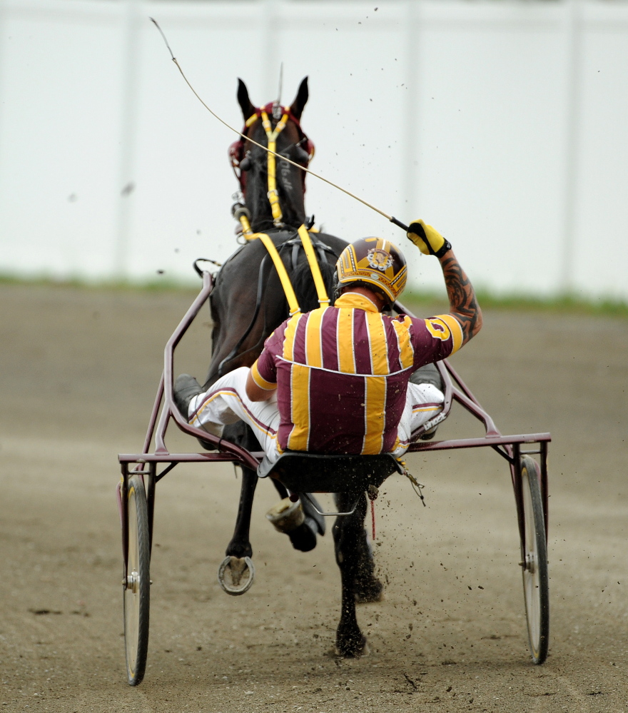 Staf file photo by Michael G. Seamans 
 Ron Cushing celebrates after winning the Walter H. Hight Invitational with Achilles Blue Chip at the Skowhegan State Fair last year.