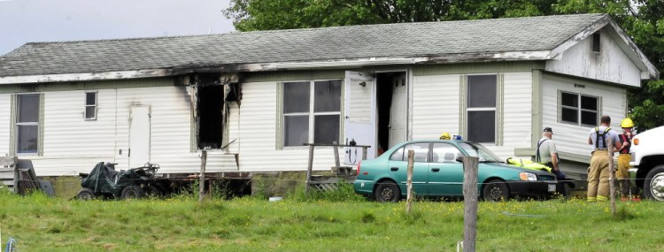 Firefighters were still at the scene several hours after fire heavily damaged a mobile home at 146 Ten Lots Road in Oakland on Sunday.