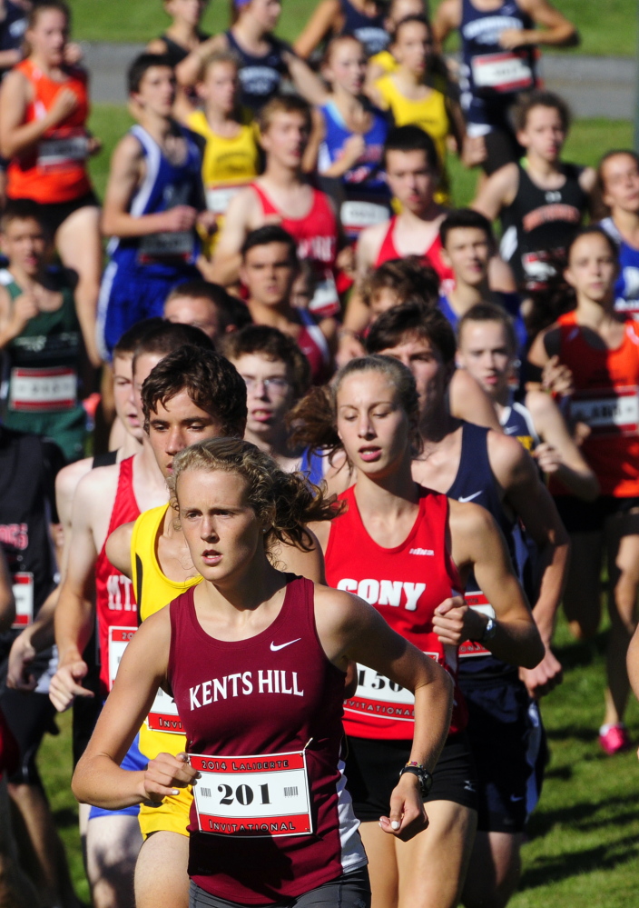 Kents Hill runner Anne McKee (201) leads Cony’s Anne Guadalupi during the 15th annual Laliberte Invitational last Aug. 29 at Cony High School in Augusta.