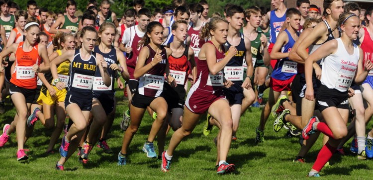 Boys and girls run across the practice football field at the start of the Laliberte Invitational on Friday at Cony High School in Augusta.