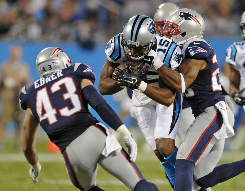 Carolina Panthers’ Jarrett Boykin (15) is tackled by New England Patriots’ Robert McClain (22) and Nate Ebner (43) during the second half of a preseason game last week in Charlotte, N.C.