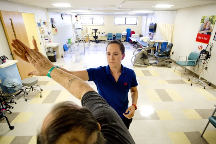 Physical therapist Rachel Boutin works with Skip Tanguay of Arundel at New England Rehabilitation Hospital. Boutin says she’s looking at 25 years to pay off her student-loan debt, now at $210,000. “I don’t think I’m ever going to be able to buy a house,” she said.
Gabe Souza/Staff Photographer