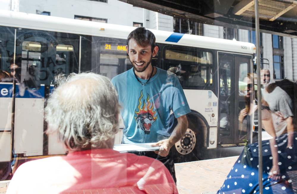 Daniel Sipe gathers signatures in August 2015 in support of a statewide minimum wage increase.  The Maine People’s Alliance, which is trying to raise Maine's minimum wage to $12 an hour, has advertised for new workers at a rate closer to $10 an hour.