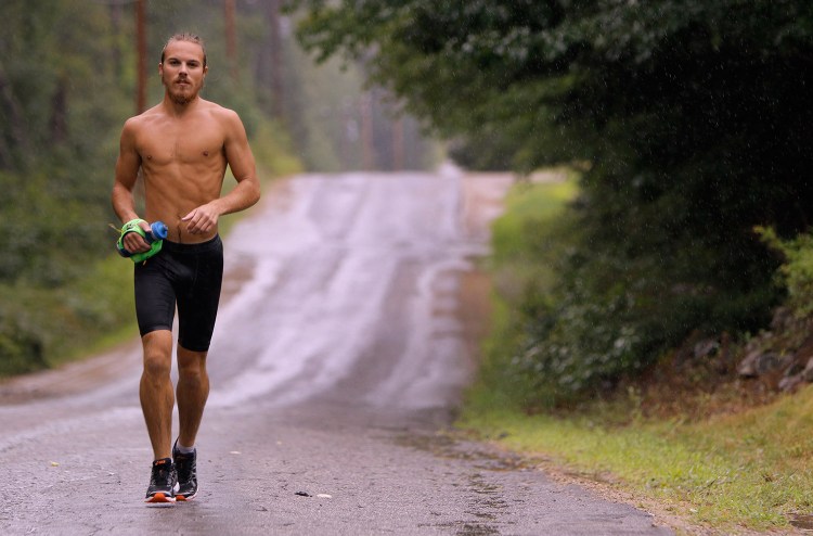 Barclay Oudersluys runs on Blanchard Road in Lebanon on Tuesday. Oudersluys is nearing the end of a 100-day, cross country run for charity that started in Los Angeles and will finish at Marshall Point Lighthouse in Port Clyde.
Gregory Rec/Staff Photographer