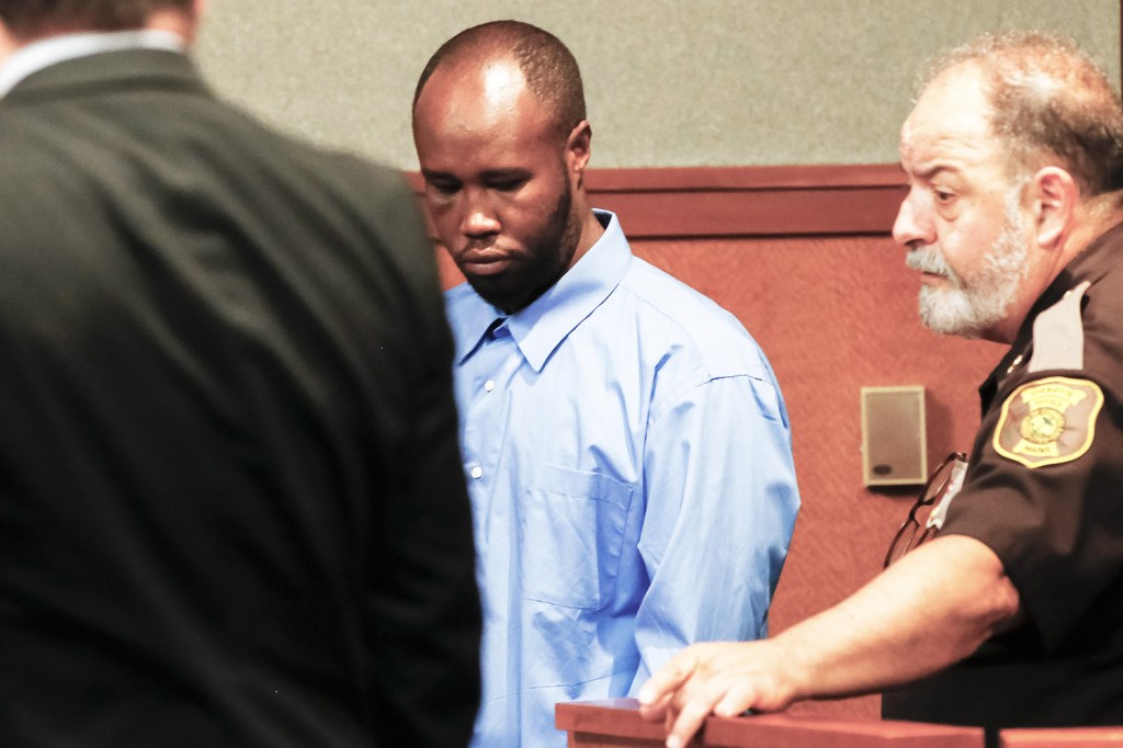 Osman Sheikh is led into Cumberland County Courthouse on Friday for an initial appearance on a murder charge in the death of Freddy Akoa of Portland.