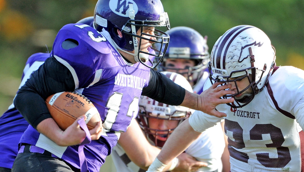 Staff file photo by Michael G. Seamans 
 Waterville's Trevor Gray, left, stiff-arms Foxcroft's Isaiah Kennell on his way to convert a fourth-down conversion in the second half of an Eastern C semifinal game last season. Gray and the Purple Panthers hope to contend for the Little Ten Conference crown yet again this season.