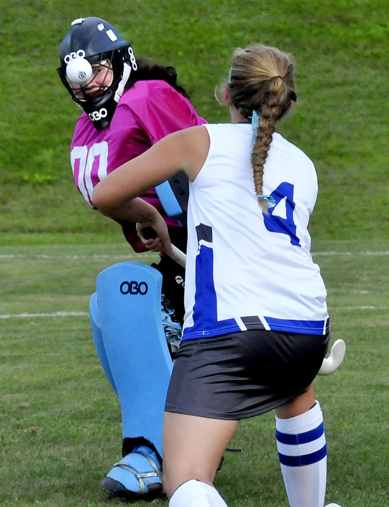 Staff photo by David Leaming 
 Nokomis goalie Chelsey Crockett keeps her eye on the ball as Lawrence's McKenna Rogers applies pressure during a Kennebec Valley Athletic Conference Class B game Thursday. Lawrence prevailed 4-1.