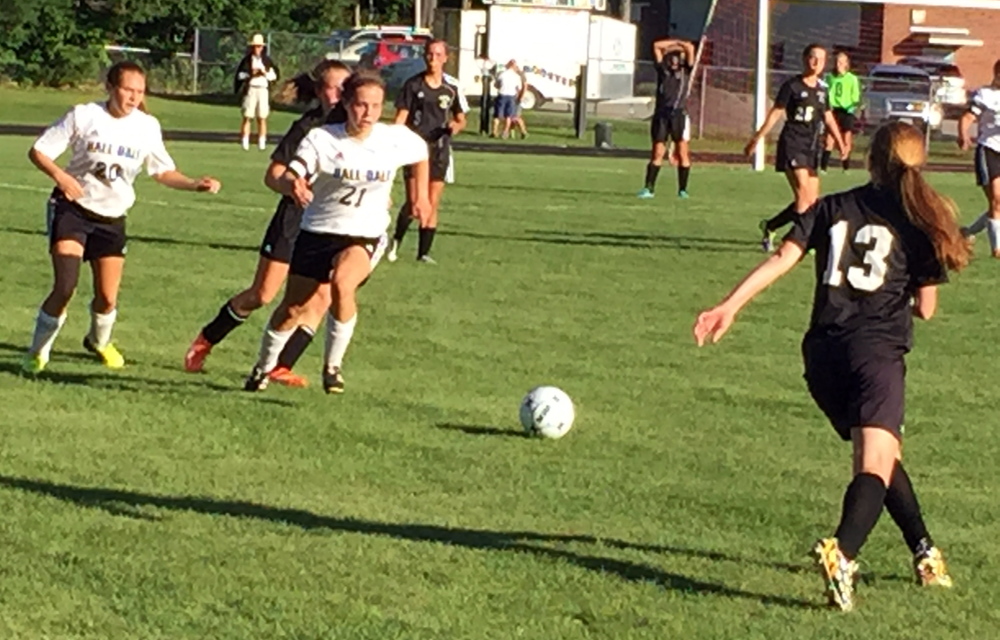 Staff photo by Randy Whitehouse 
 Hall-Dale's Signe Lynch (21) chases a loose ball during a game against St. Dom's on Friday afternoon in Farmingdale.