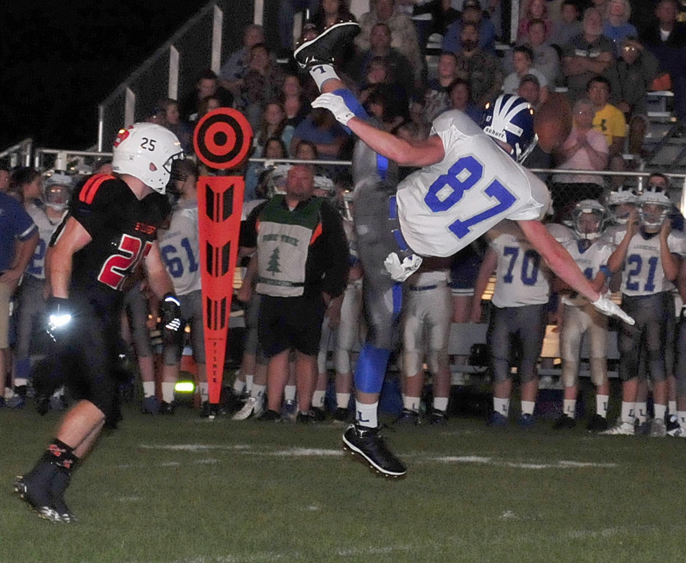 Staff photo by David Leaming 
 Lawrence's Seth Powers goes up to try and haul in a pass during a Pine Tree Conference Class B game Friday night at Clark Field in Skowhegan.