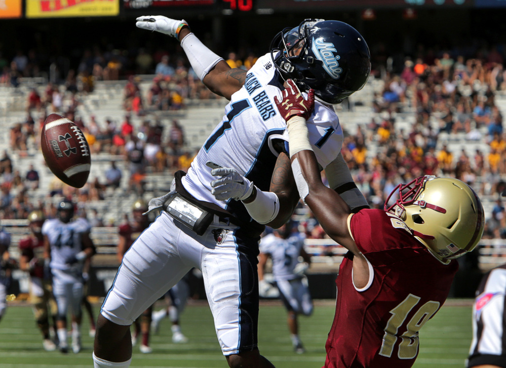 Barry Chin/The Boston Globe via AP
Maine defensive back Najee Goode (1) breaks up a pass intended for Boston College wide receiver Thadd Smith (18) in the first quarter Saturday in Chestnut Hill, Mass.