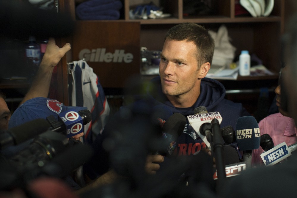 New England Patriots quarterback Tom Brady speaks in the locker room at Gillette Stadium prior to the team’s practice Sunday in Foxborough, Mass.