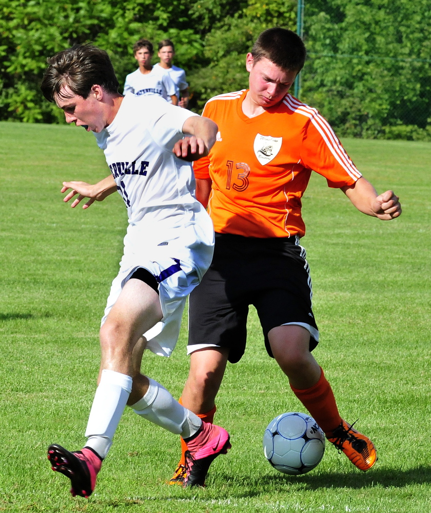 Staff photo by David Leaming 
 Waterville's Ethan Cayer, left, and Winslow's Hunter McCaslin scramble for the ball  during a game Tuesday at Webber Field in Waterville.