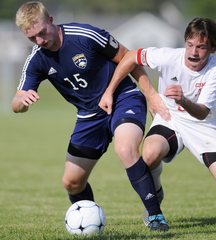 Staff photo by Andy Molloy 
 Cony High School's Brett Sproul, right, attempts to block Mt. Blue's Liam Welch during a Kennebec Valley Athletic Conference Class A game Tuesday in Augusta.