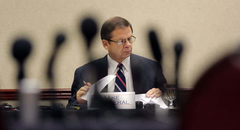 AP photo 
 Mike Motheral, chairman of the University Interscholastic League (UIL) State Executive Committee, is seen through a cluster of microphones during an emergency meeting Wednesday in Round Rock, Texas. The UIL, the governing body for high school sports in Texas, called the meeting to investigate two John Jay High School football players who hit a referee and the surrounding events.