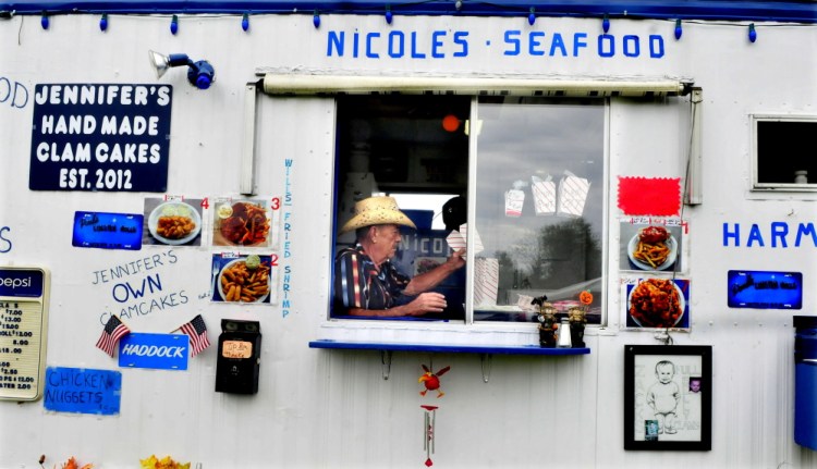 Paul Blais prepares takeout boxes for clams he sells at Harmon’s Clams at the Clinton Lions Club fair on Thursday. The fair runs through Sunday.