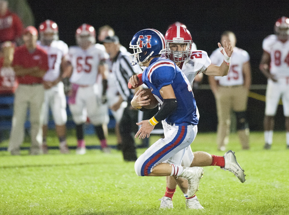 Kevin Bennett photo 
 Cony's Lucas Tyler strips the ball from Messalonskee's Caleb Chavarie during the second quarter of a Pine Tree Conference Class B game Friday night at Veterans Field in Oakland. Cony recovered the ball.