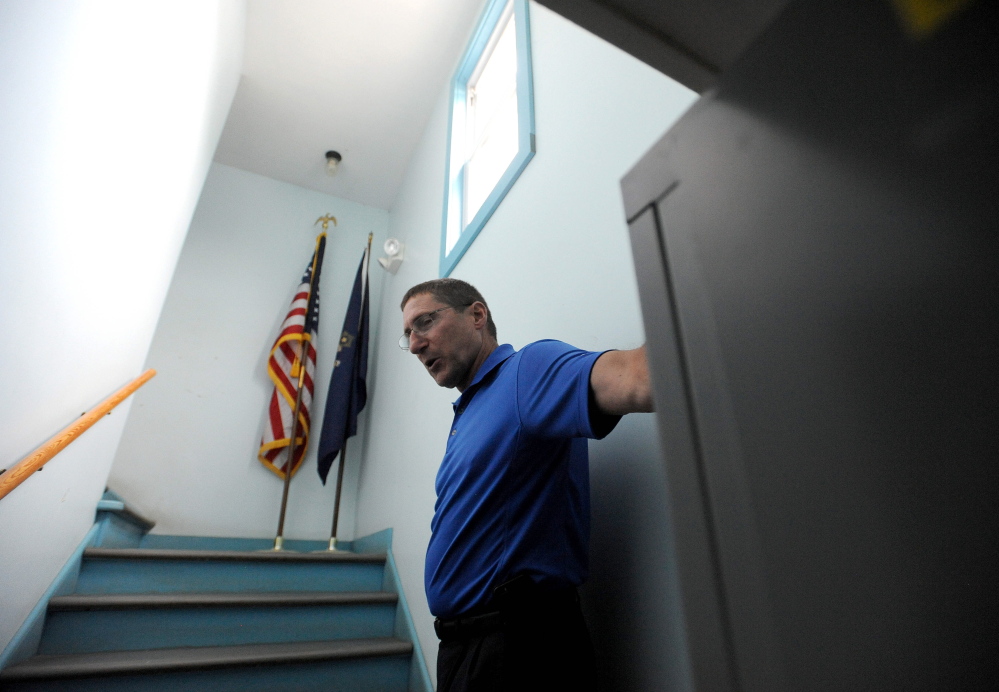 Michael Tracy, Oakland chief of police, gives a tour of the police station in July. The town will hold public hearings ahead of a November vote on whether a new station should be built. The first hearing is Thursday.