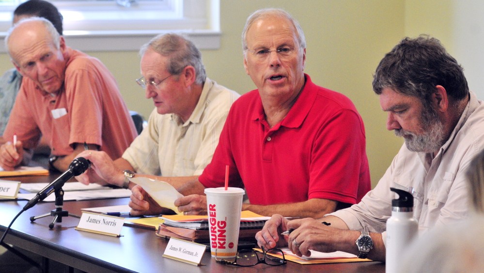 Public members of the board Ben Emory, left, Neil Piper, James Norris and James W. Gorman Jr., are seen during a meeting of the Land For Maine’s Future board on Tuesday in Augusta. There were four public members there but the board didn’t have a quorum because none of the three commissioners attended.