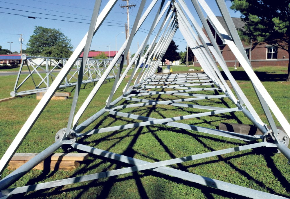 Matt Hussey of Hussey Communications, center, makes preparations on Tuesday to intall the 140-foot radio tower in front of the Waterville Police Department. The company will put up the 140-tower beginning at 9 a.m. Thursday.