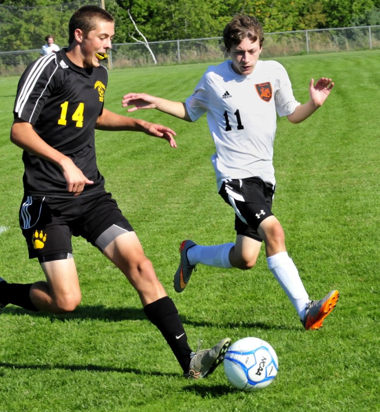 Staff photo by David Leaming 
 Maranacook's Hayden Elwell, left, and Winslow's Isaac Lambrecht chase the ball during game Thursday in Winslow.