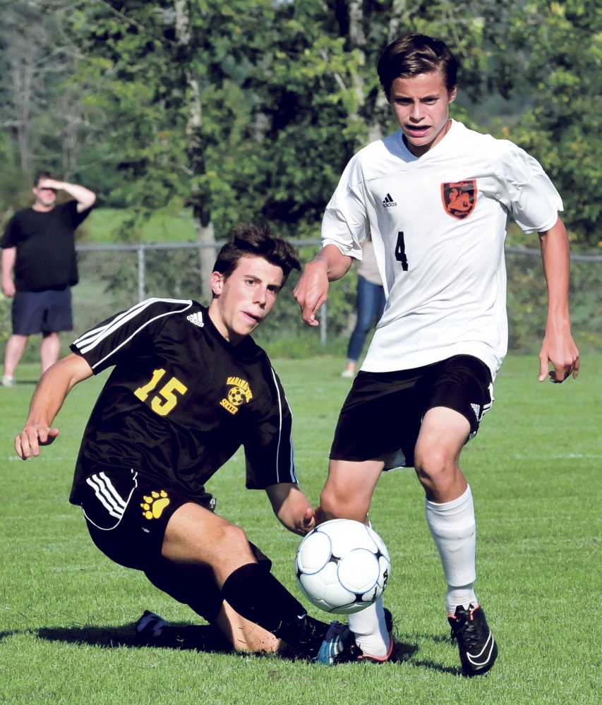 Staff photo by David Leaming 
 Maranacook's Carlo Bozzola, left, and Winslow's Spencer Miranda compete possession during a game Thursday in Winslow.