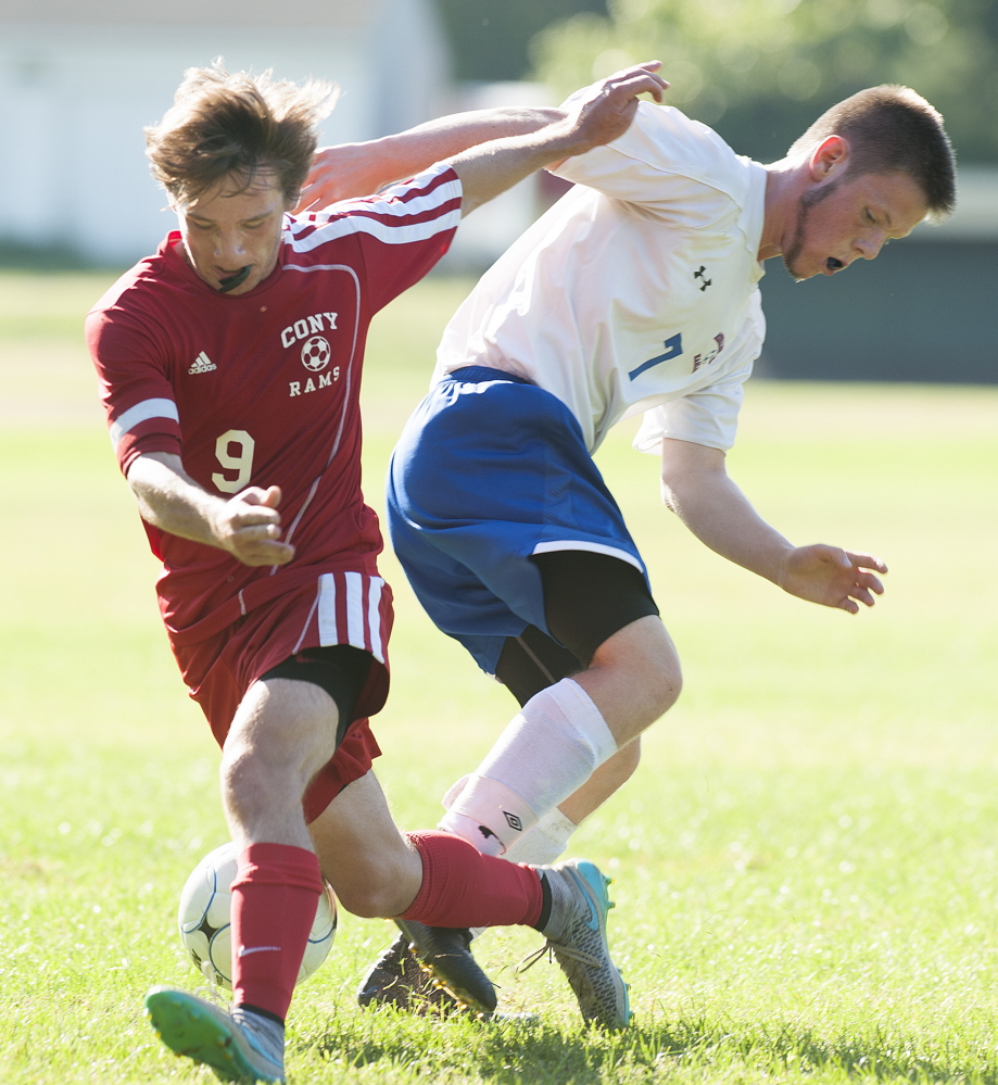 Kevin Bennett photo 
 Cony's Brett Sproul, left, and Messalonskee's Dan Turner seek control of the ball during a Kennebec Valley Athletic Conference Class A game Friday afternoon.