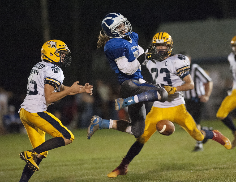 Lawrence’s Walker Thomas has his catch broken up by Mt. Blue’s Chase Heikkinen during the second quarter Friday in Fairfield.